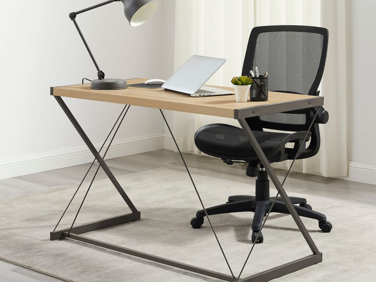 The Insignia™ - Ergonomic Mesh Office Chair with Adjustable Arms at a desk.