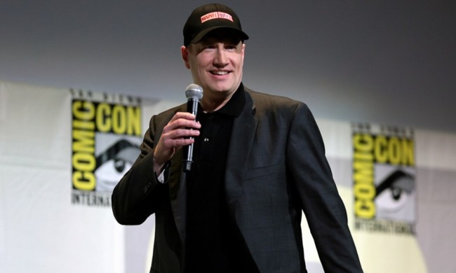 Kevin Feige holds a microphone onstage at Comic-Con.