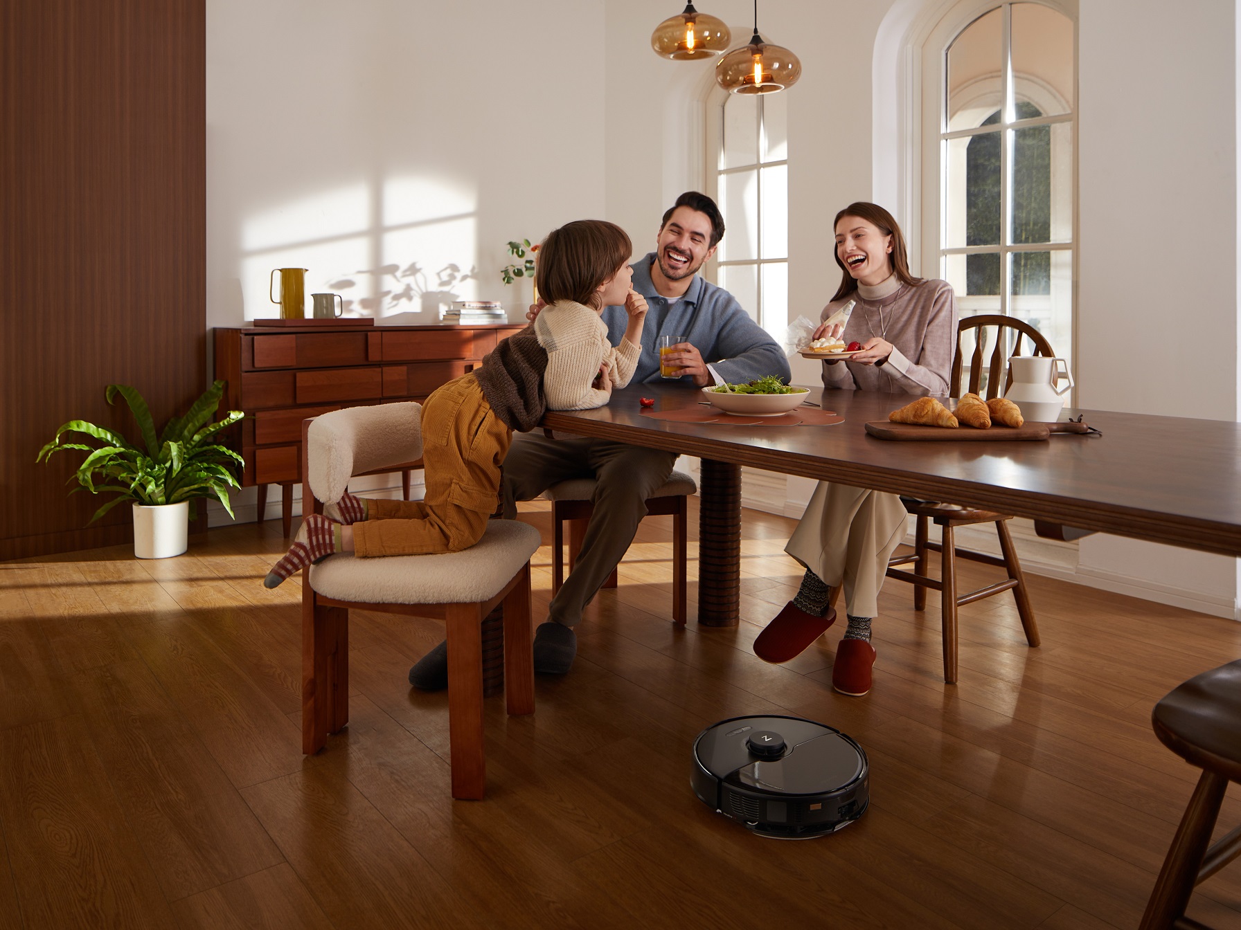 Roborock S8 Max Ultra cleaning under dining table with family