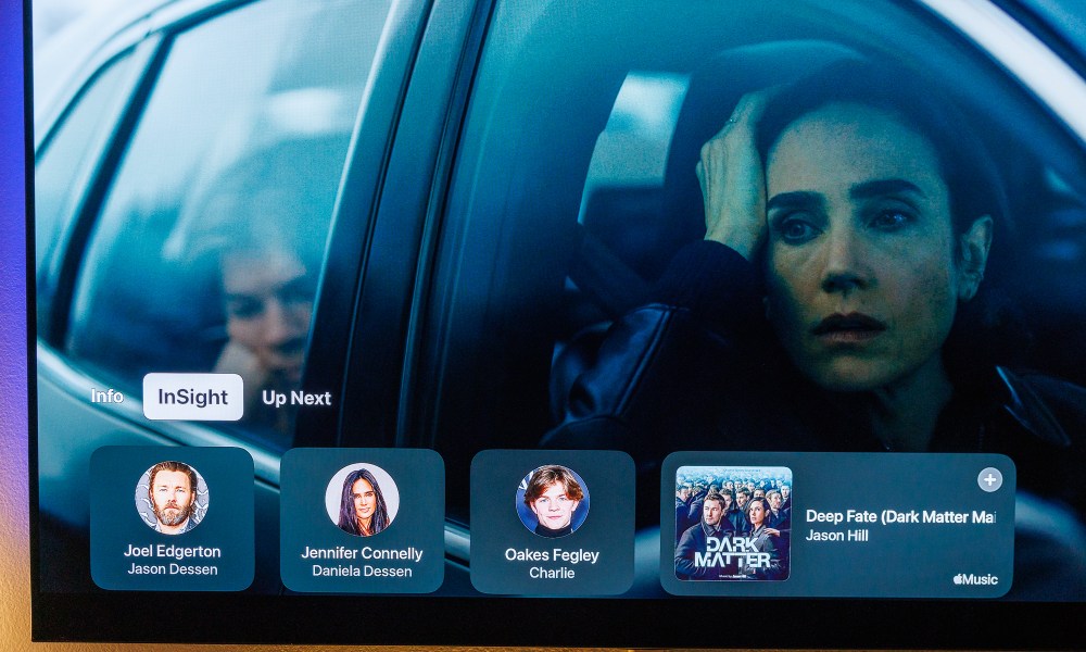 Apple TV's Insight feature showing character and music information on screen.