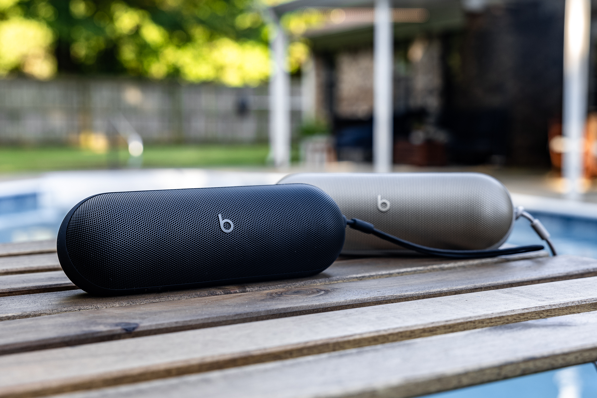 Two Beats Pills sit by a pool.