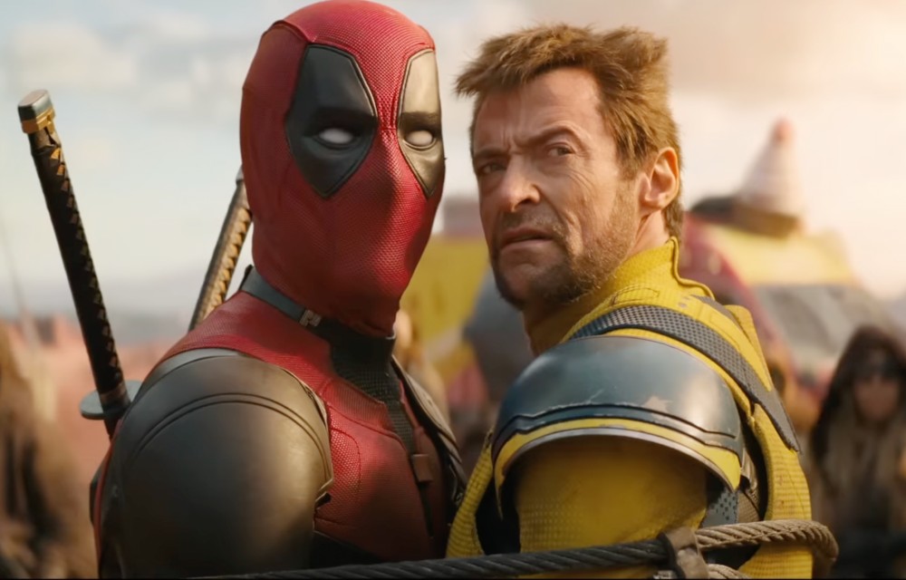 Two men stand close to each other in Deadpool & Wolverine.