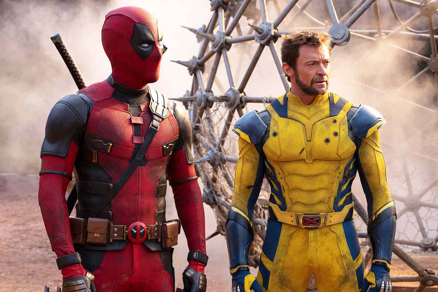 Deadpool (Ryan Reynolds) and a yellow-suited Wolverine (Hugh Jackman) stand in a dusty wasteland