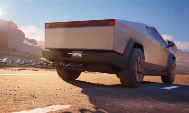 The back of a cybertruck towing something with a chain. It's in a desert with a bright blue sky.