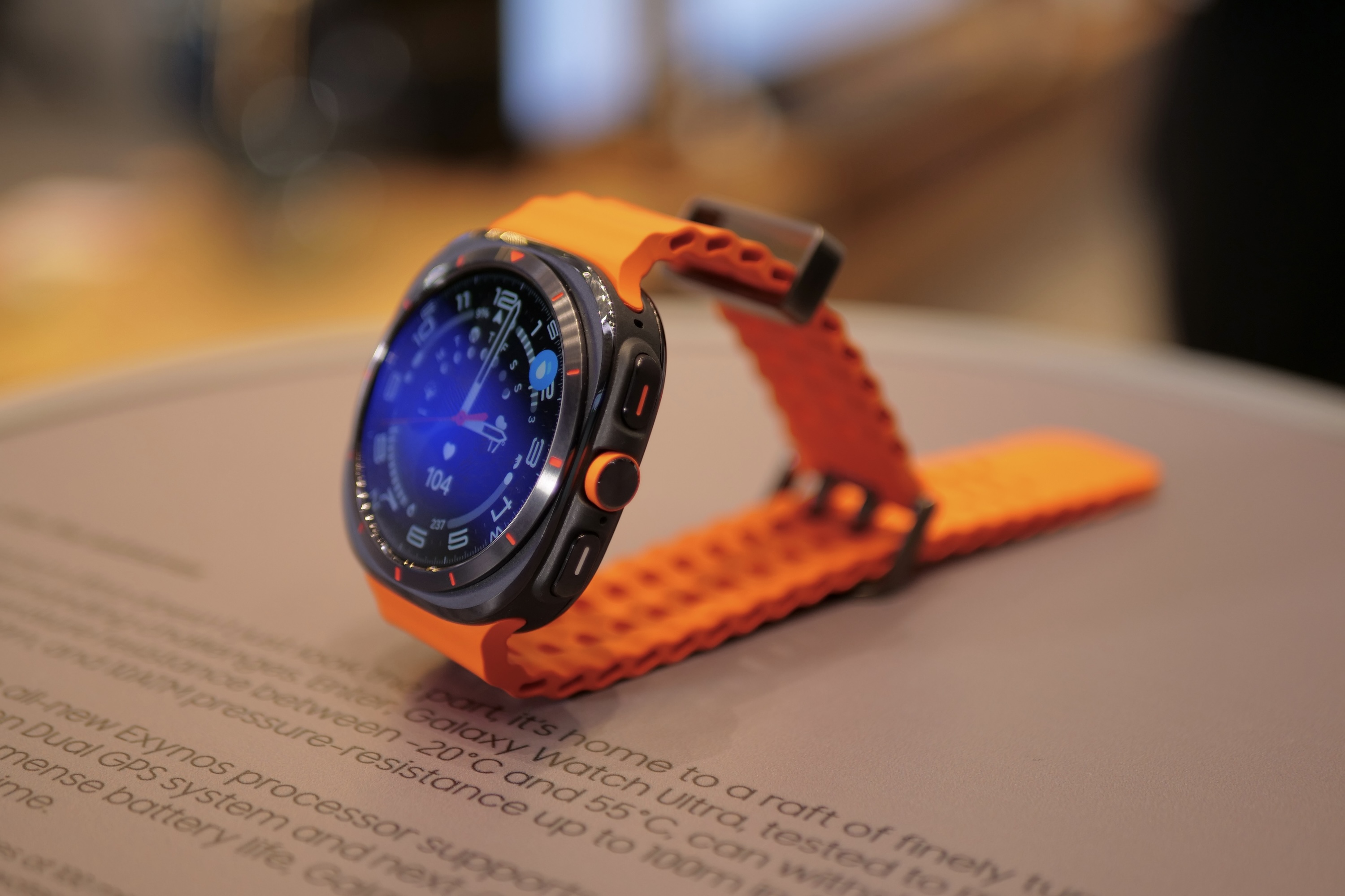 The Samsung Galaxy Watch Ultra in black with an orange strap.