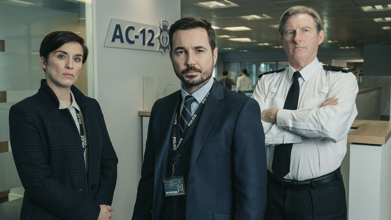 A woman and two men standing in uniforms in a scene from Line of Duty on Hulu.