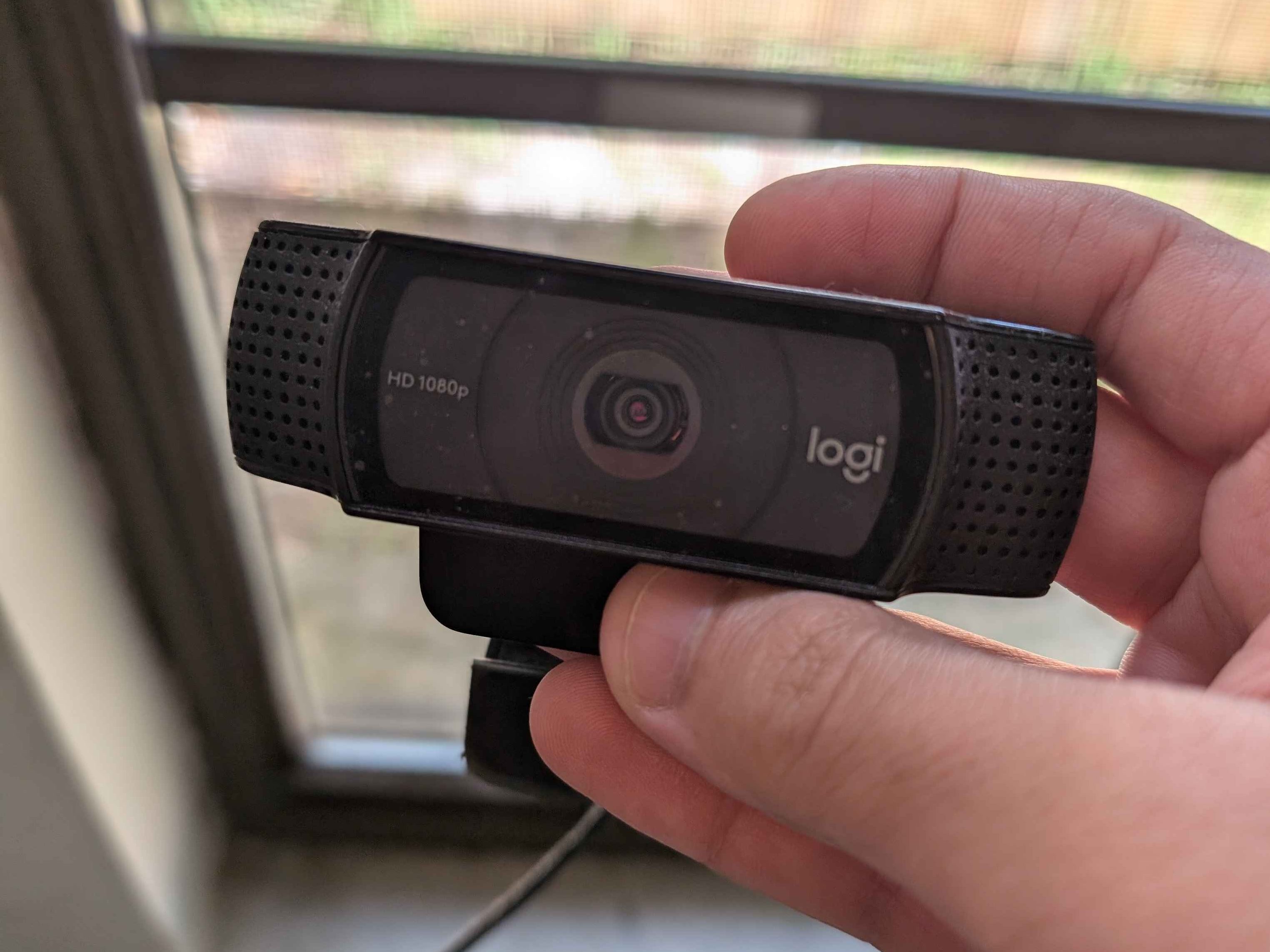 I'm holding my Logitech C920 1080p webcam in my hands.