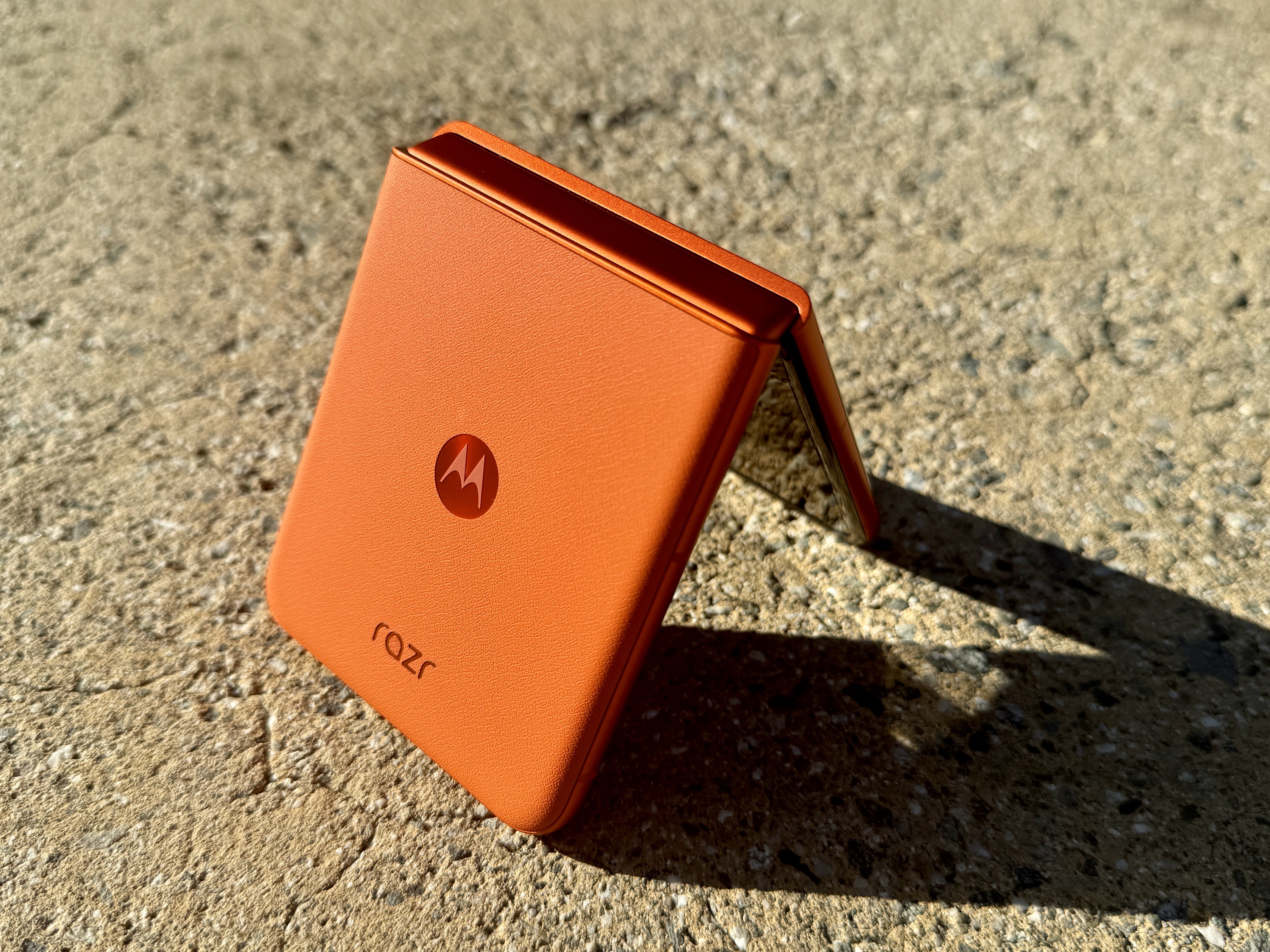 Motorola Razr 2024 in Spritz Orange propped open in tent mode.