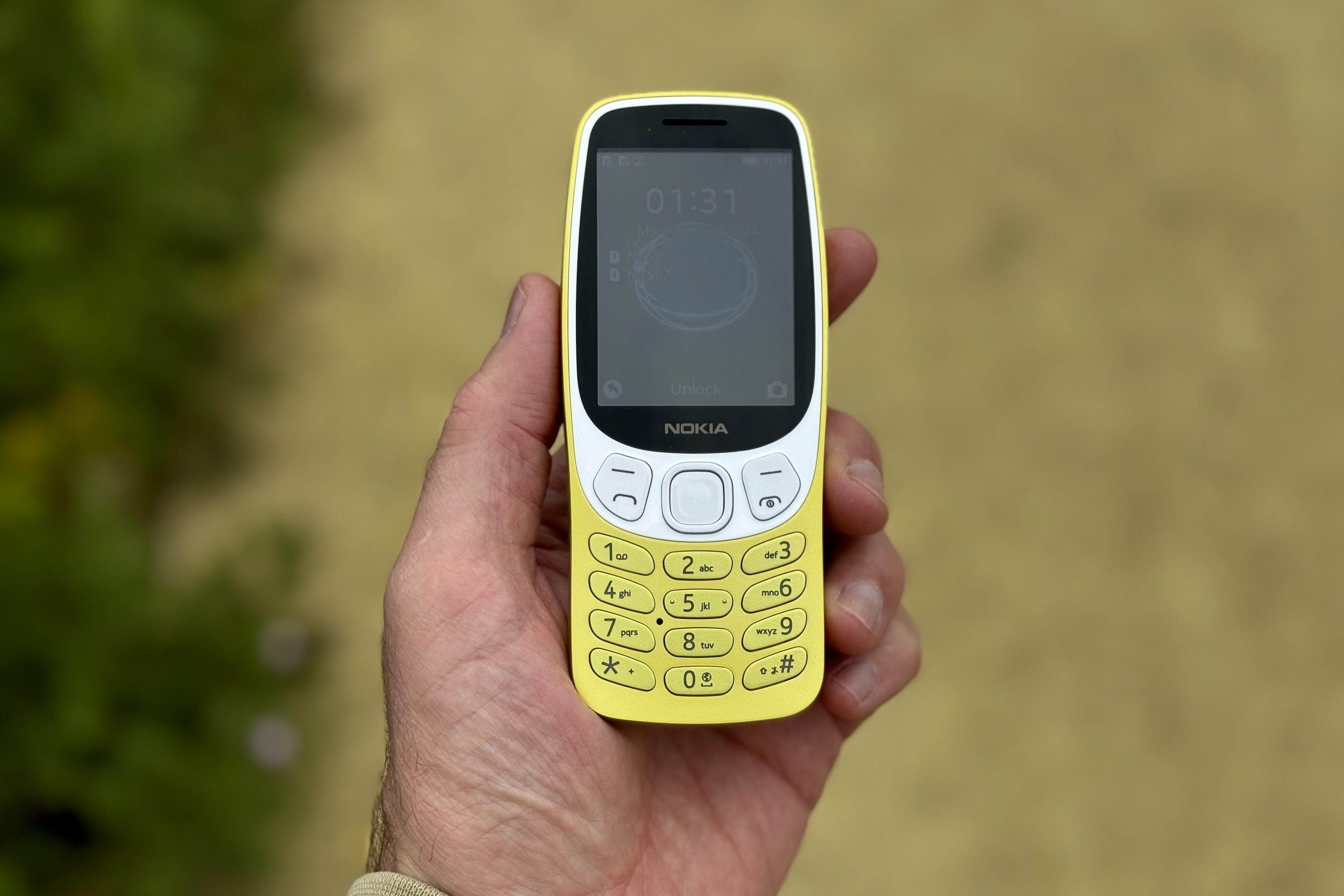 A person holding the Nokia 3210.