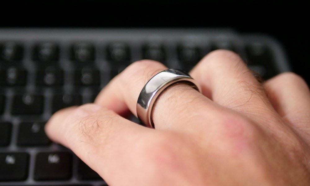 A person typing wearing the Oura Ring.