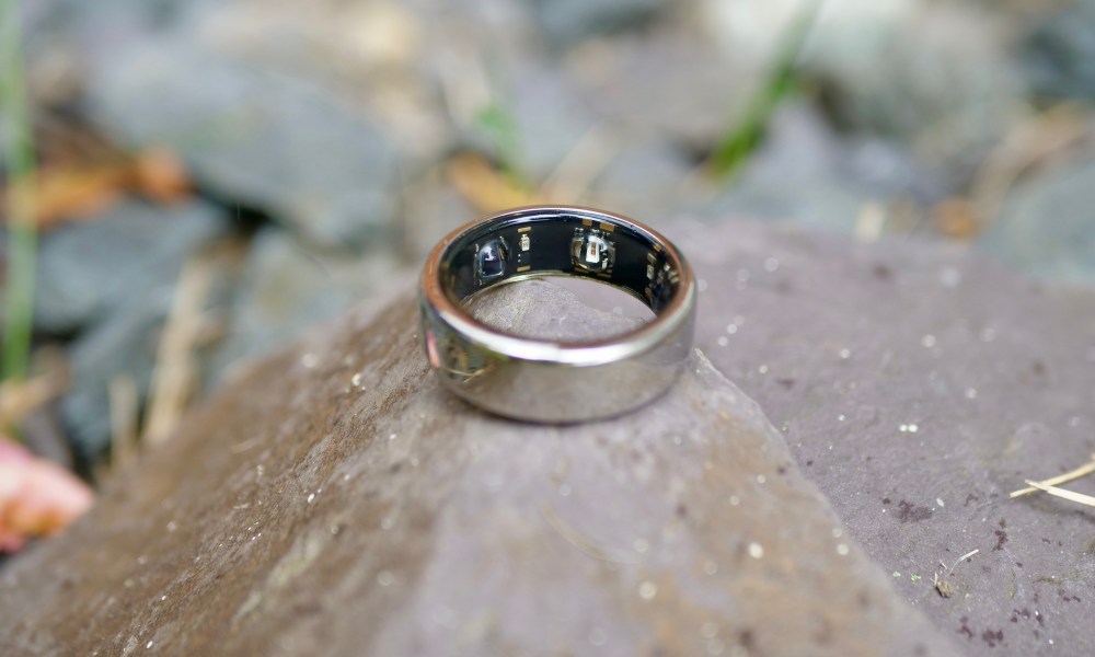 The Oura Ring resting on a rock.