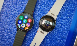 Two Samsung Galaxy Watch 7 smartwatches laying next to each other on a table.