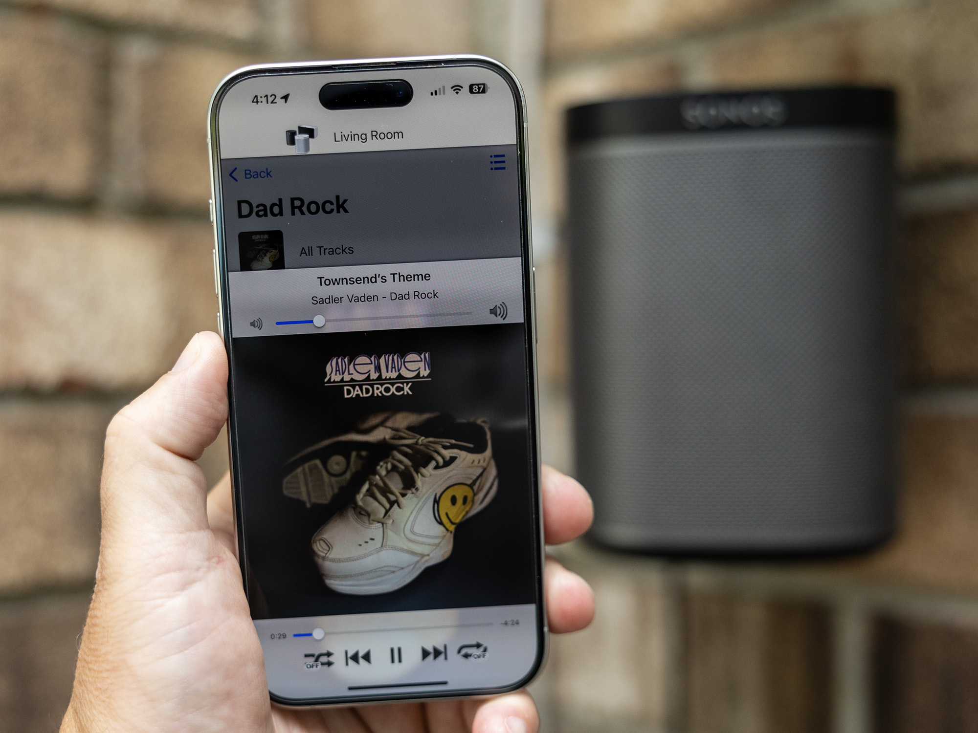 The SonoPhone app on an iPhone in front of an old Sonos speaker.