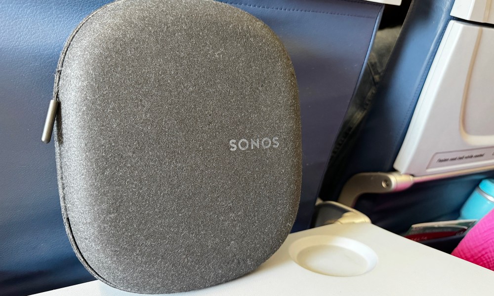 The Sonos Ace headphones case sitting atop an airplane tray table.