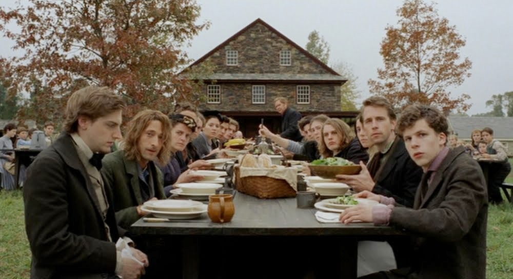 A group of people eat at a dinner table in The Village.