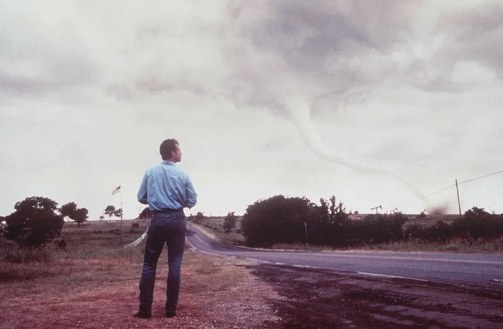 A man looks at a tornado in Twister.