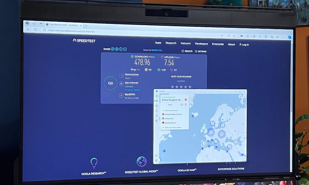 A NordVPN speed test is open on a PC monitor.