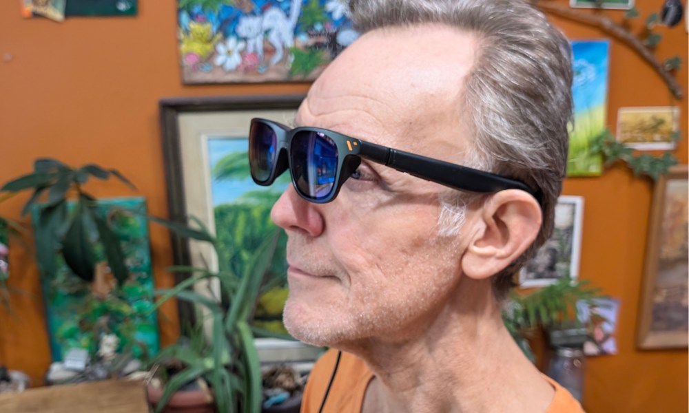 Alan Truly wears Viture Pro smart glasses.