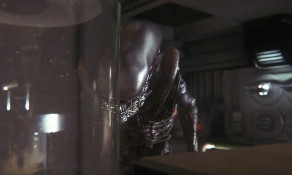 The Xenomorph lurks behind glass in a screenshot from the game Alien: Isolation.