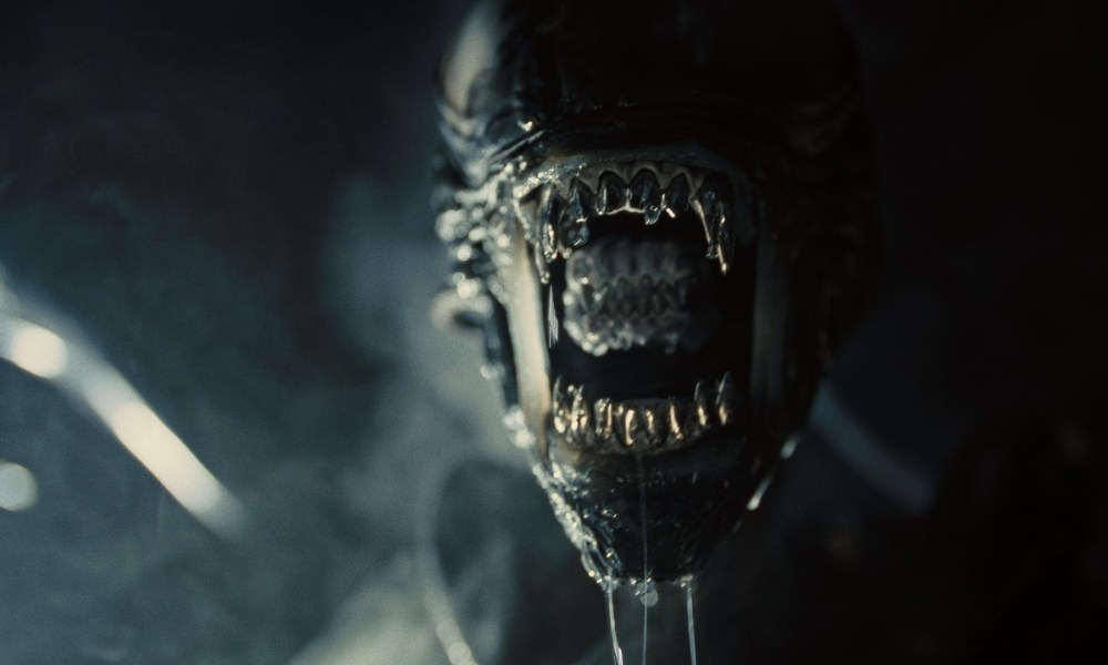 The Xenomorph hisses in close-up in a still from the movie Alien: Romulus.