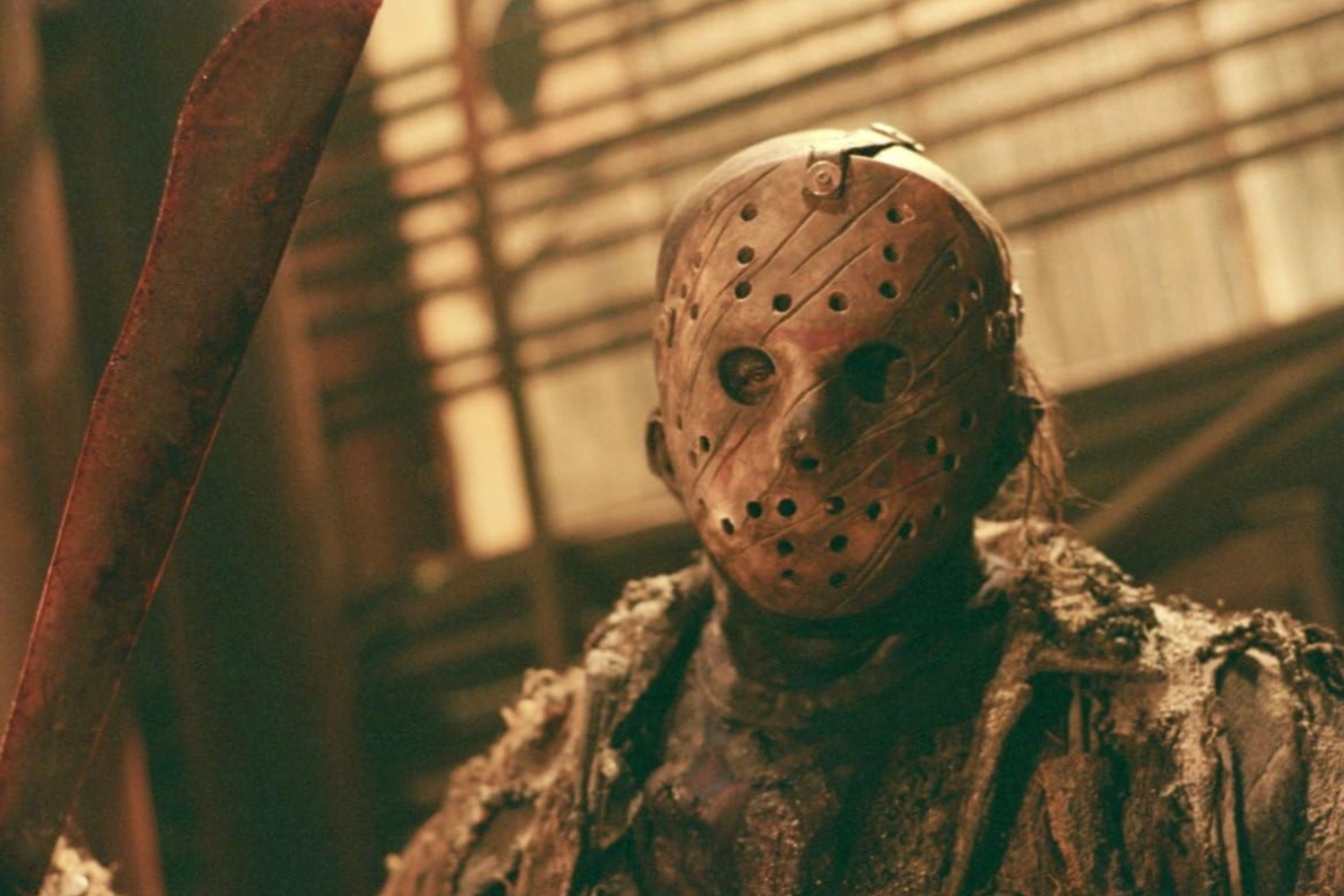 Jason Voorhees holds up a knife and stares.