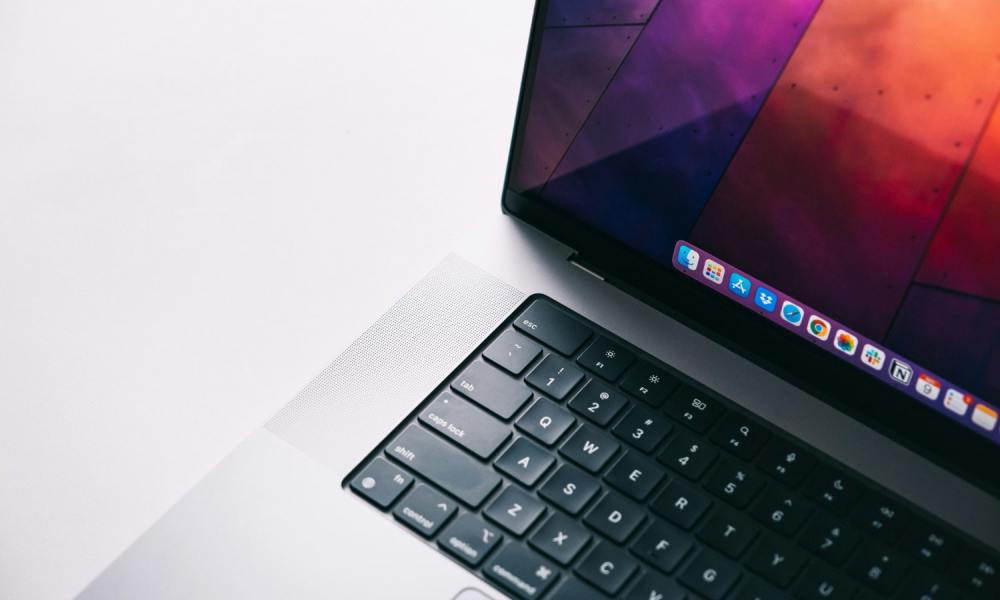 A close up of a MacBook Pro against a white background.