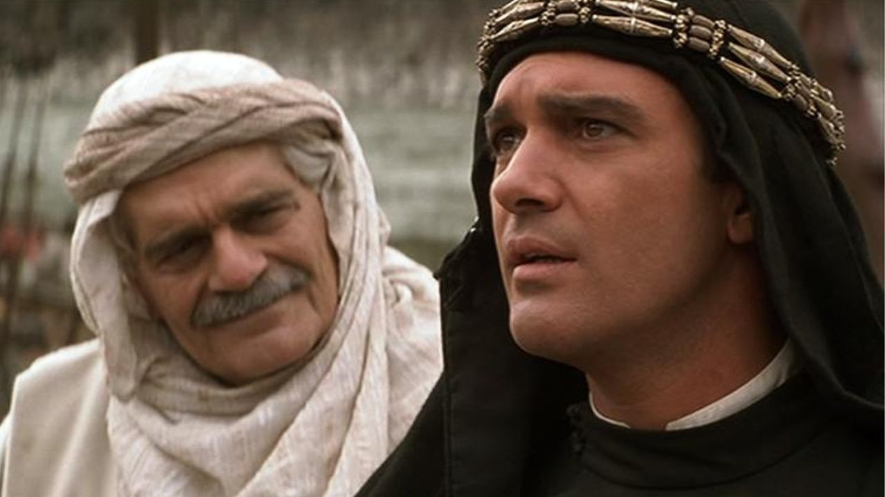 Omar Shariff as Melchisidek looking at Antonio Banderas as Ahman ibn Fadlan, who's looking to the distance, in The 13th Warrior.