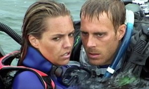 Blanchard Ryan and Daniel Travis huddle close in their wetsuits in a still from the movie Open Water.