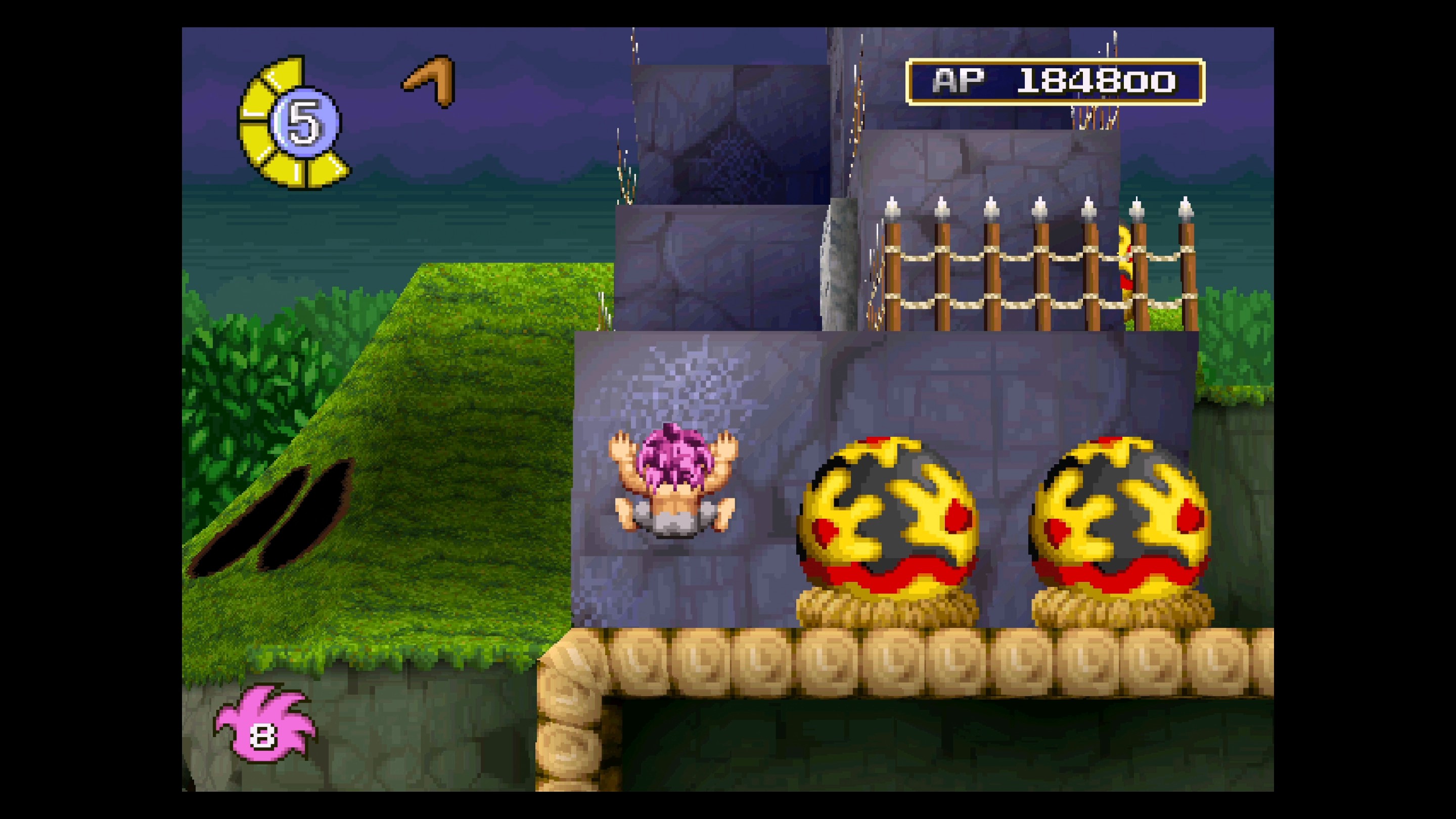 Tomba climbs a wall in the background in Tomba! Special Edition.