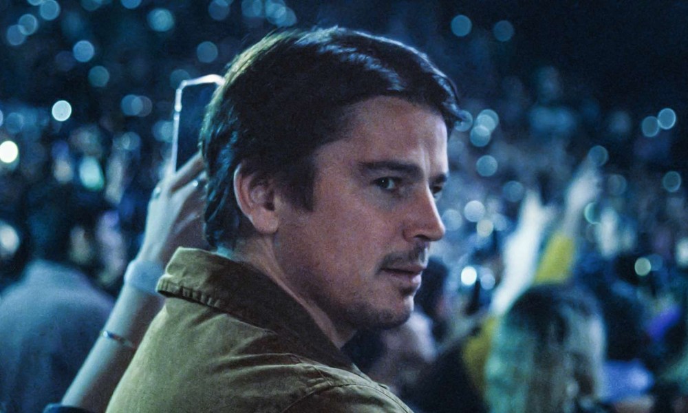 Josh Harnett surveys a concert hall in a still from the movie Trap.