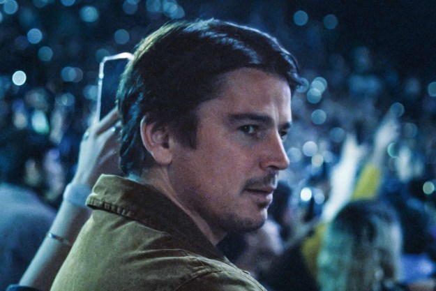 Josh Harnett surveys a concert hall in a still from the movie Trap.