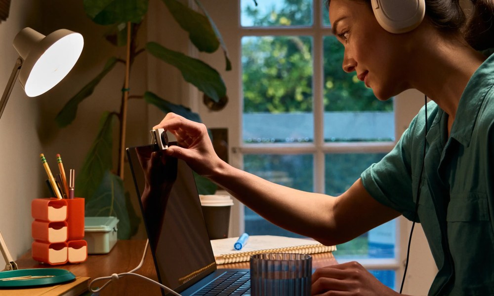 Woman using the Opal Tadpole webcam on her laptop for meeting