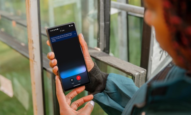 Person holding a phone with Google Gemini Live being shown.