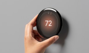 Someone adjusting the temperature on the Google Nest Learning Thermostat (4th Gen).