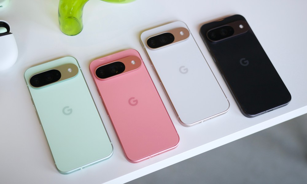 The Google Pixel 9 in green, pink, white, and black colors, all laying on a white table.