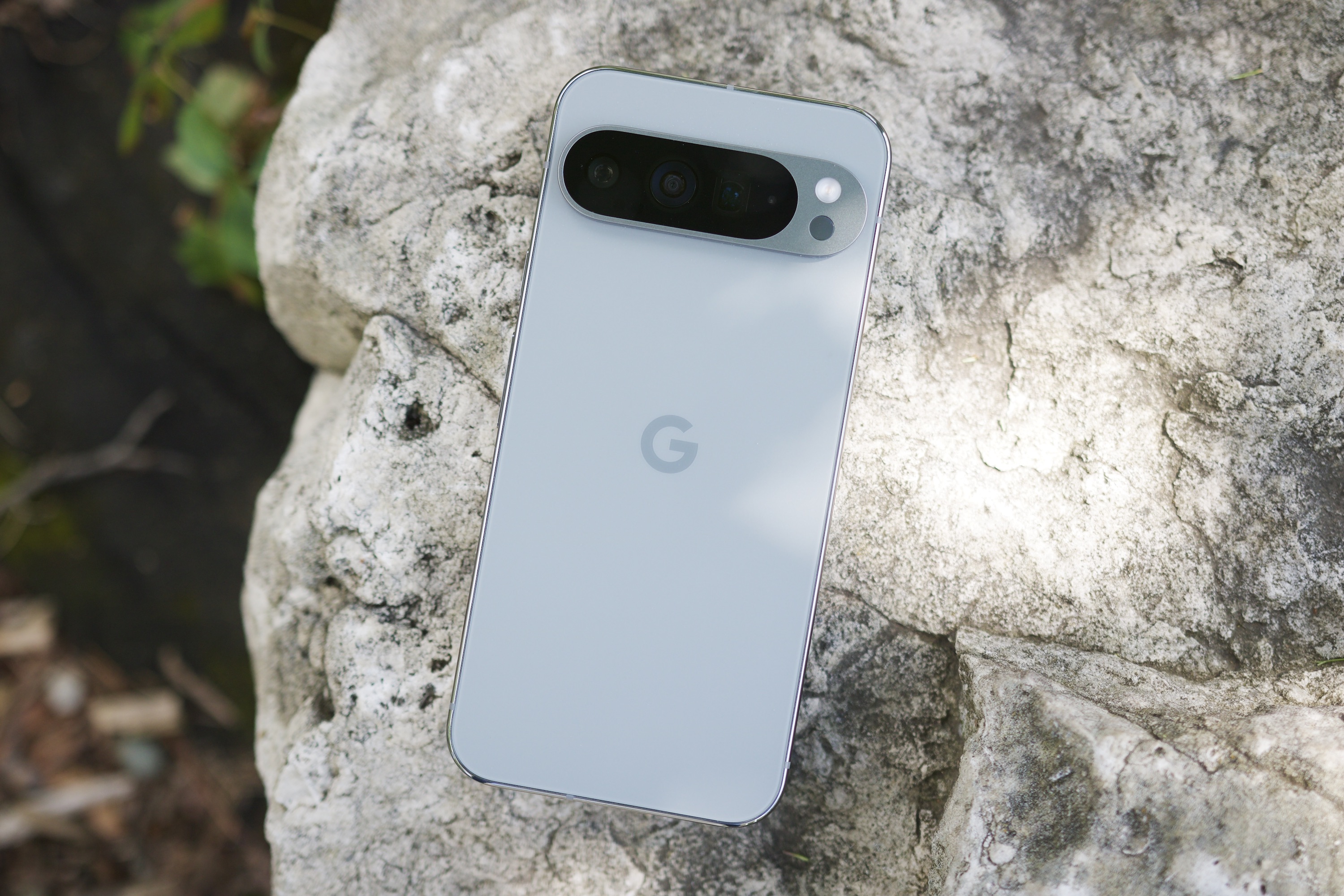 The Google Pixel 9 Pro XL laying face-down outside.