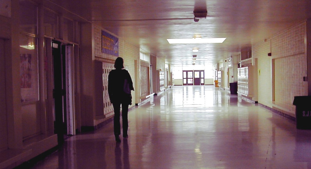 A teenage girl walks a hallway in high school in My So-Called Life.