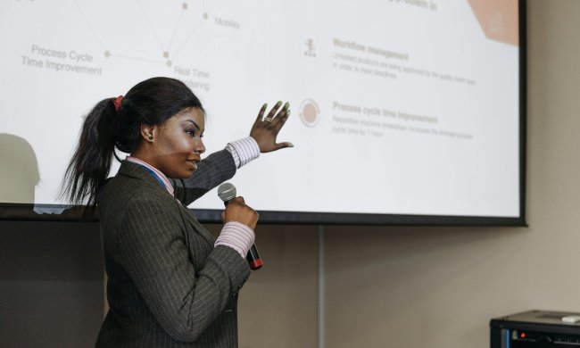 a professional woman giving a slideshow presentation