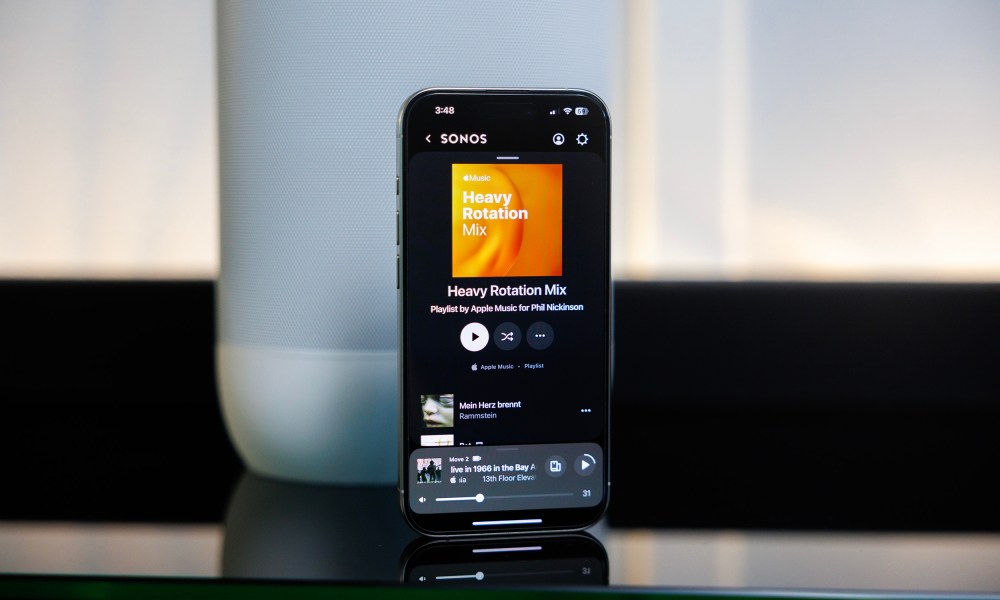 The Sonos app on an iPhone in front of a Sonos Move 2 speaker.
