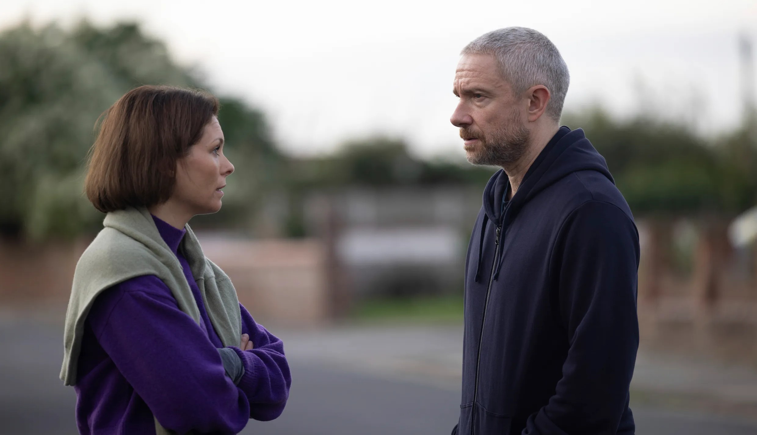 A man talks to a woman in The Responder.