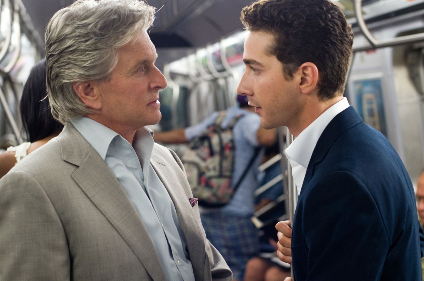 Two men talk on the subway in Wall Street: Money Never Sleeps.