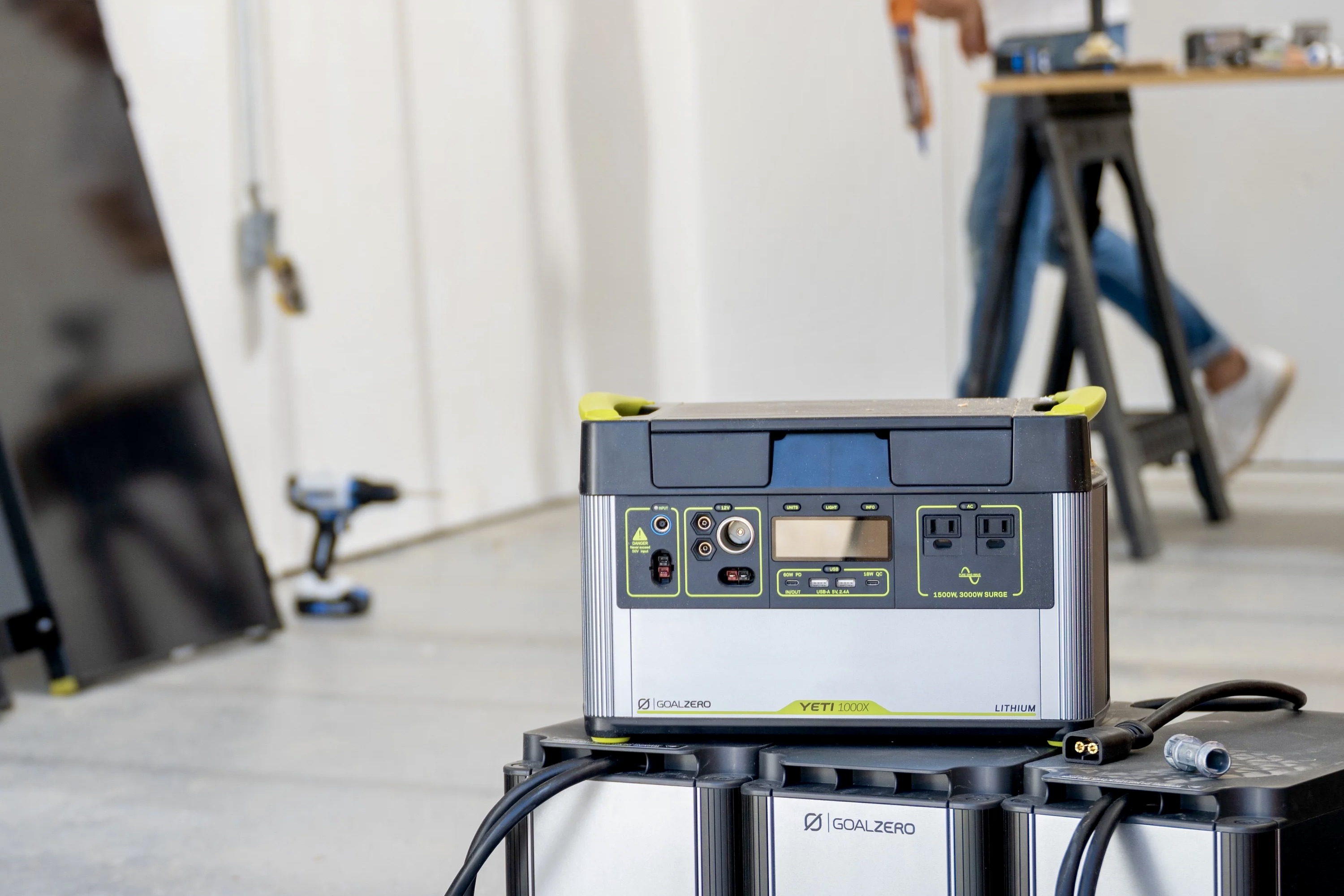 A person uses the Yeti 1000X portable power station on a construction site.