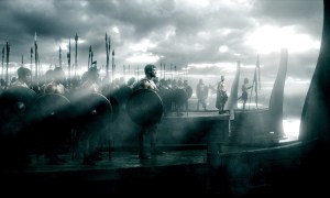 Men stand on boats in 300: Rise of an Empire.