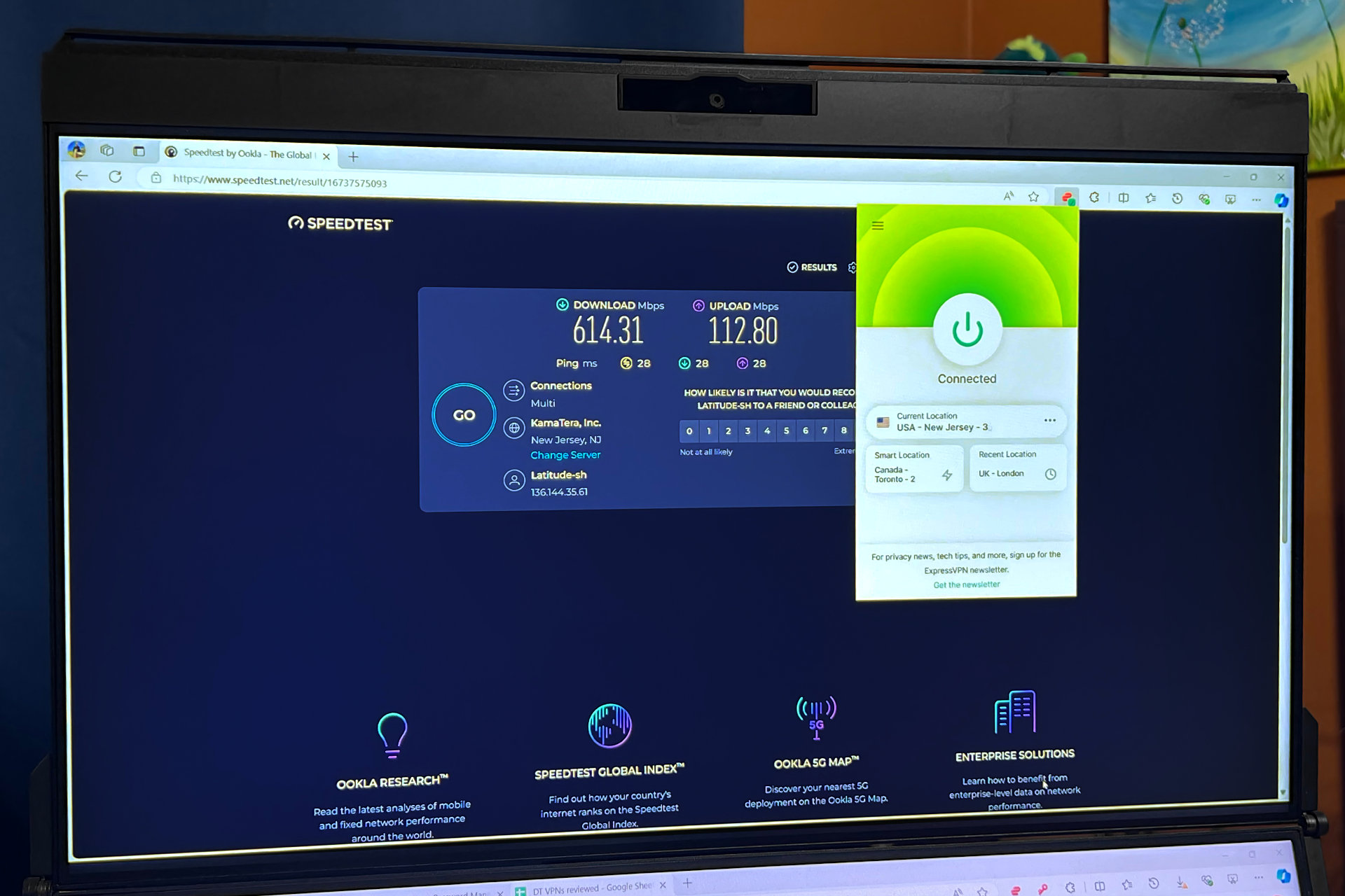 expressvpn review a pc monitor shows s browser extension in use while testing its speed