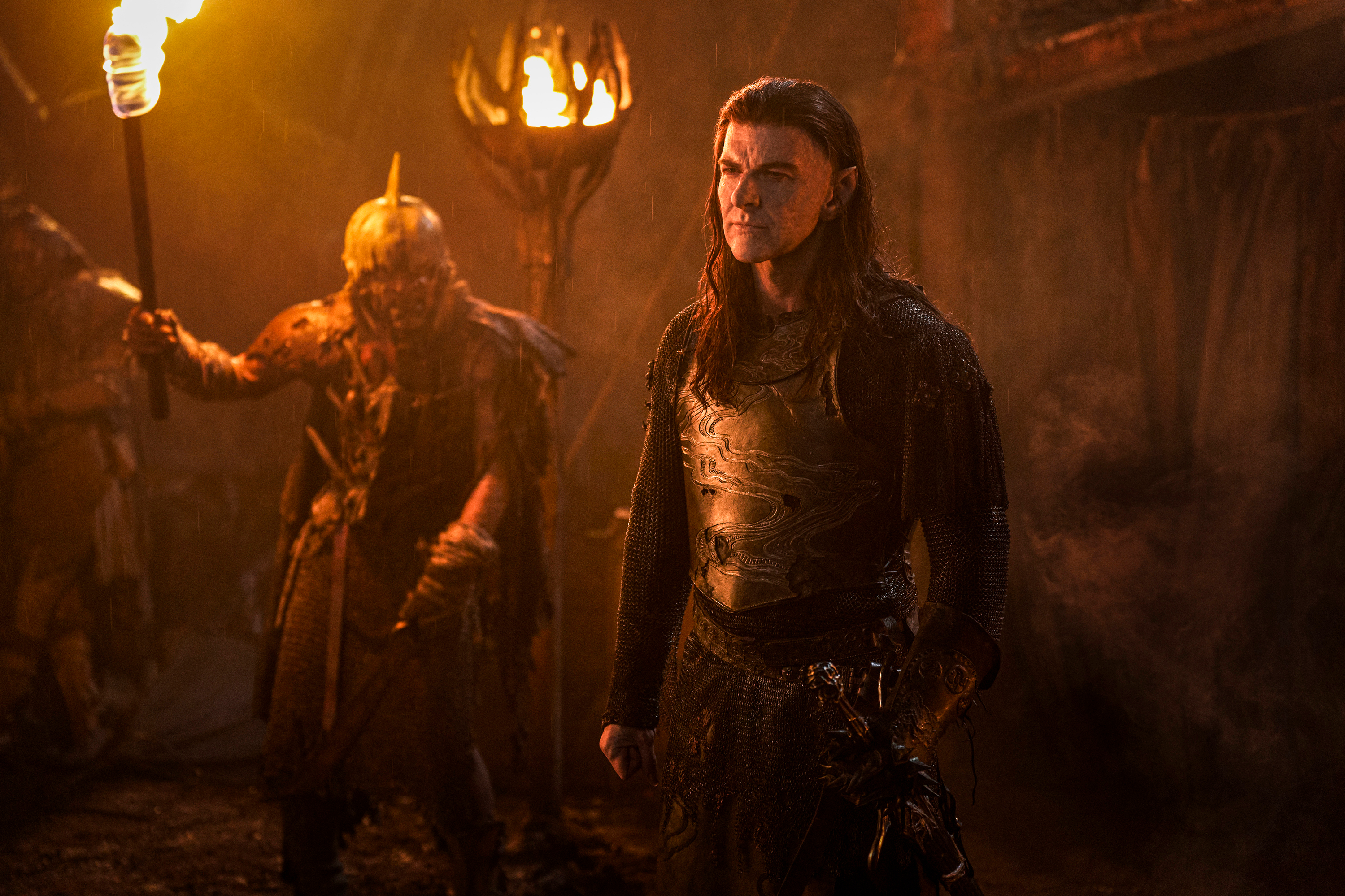 Adar stands near an orc in the second season of The Lord of the Rings: Rings of Power.