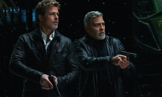 Brad Pitt and George Clooney hold guns in Wolfs.