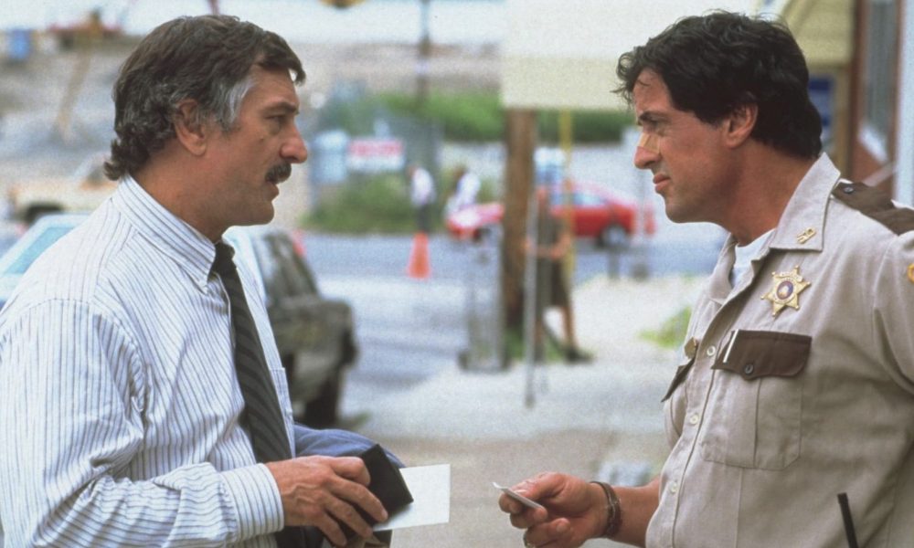 A man stands in front of a cop and bargains.