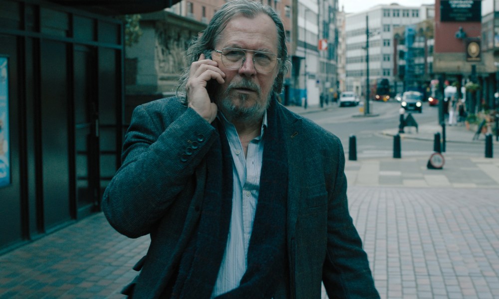 Gary Oldman walks while talking on the phone in Slow Horses season 4.