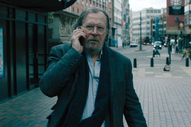 Gary Oldman walks while talking on the phone in Slow Horses season 4.