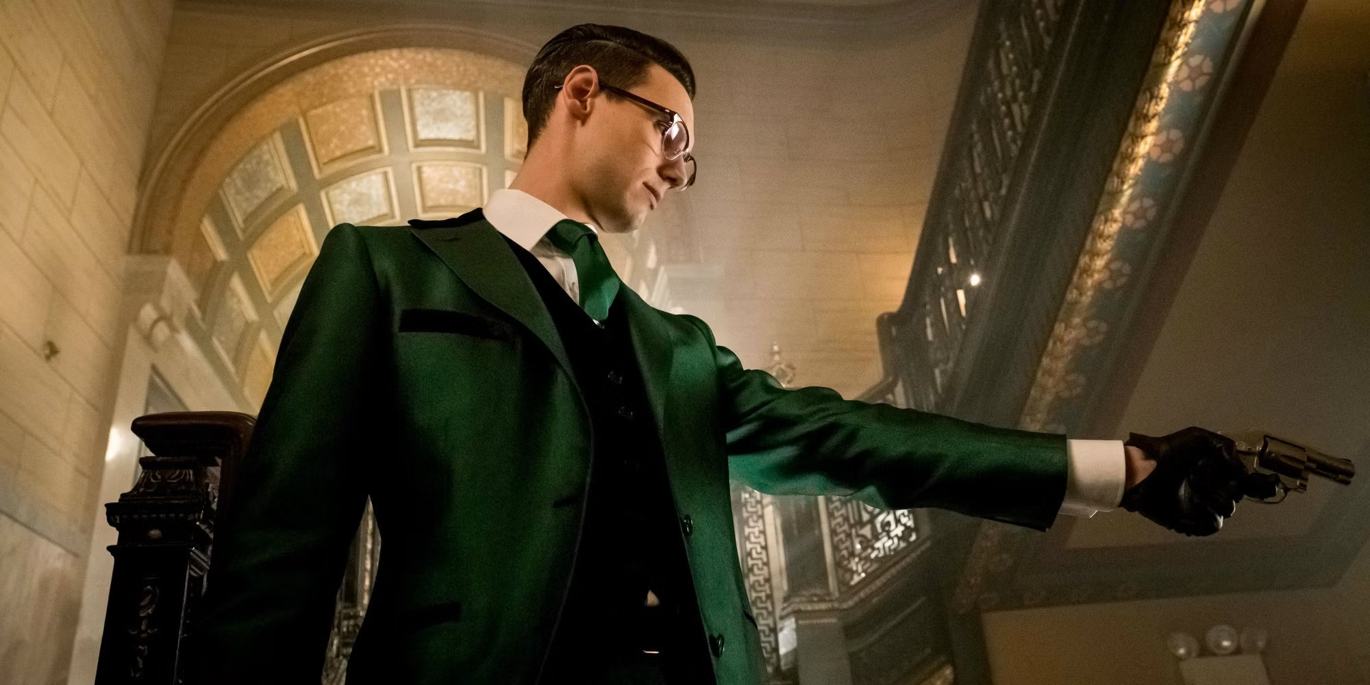 The Riddler aims his gun at Gotham.